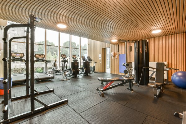 a small gym full of exercise equipment