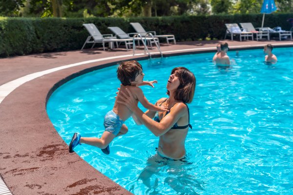 mother and son playing in the pool