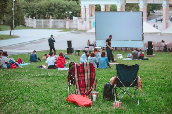 people gathered for an outdoor movie night with a projector