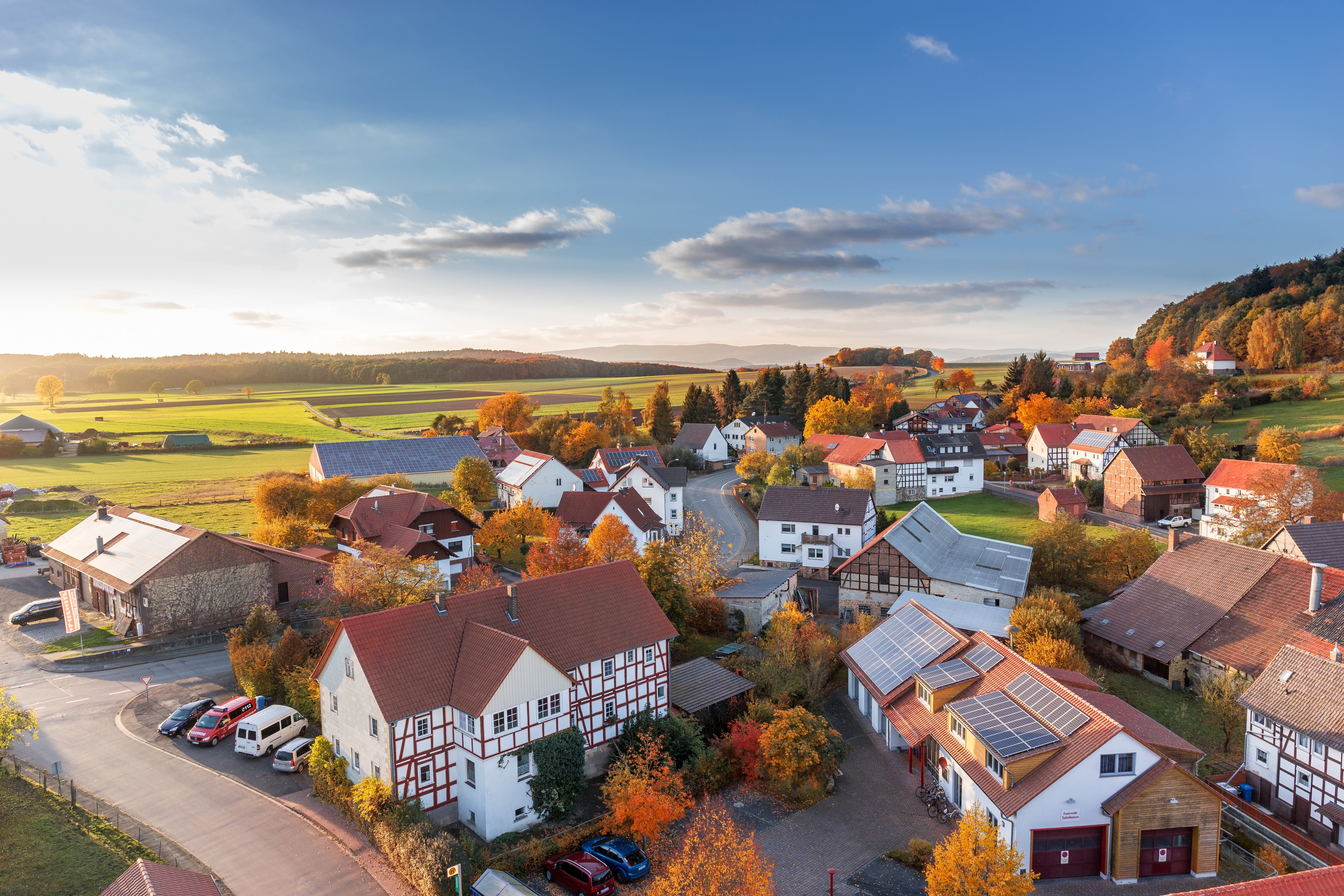 An aerial view of a neighborhood in the fall. 
