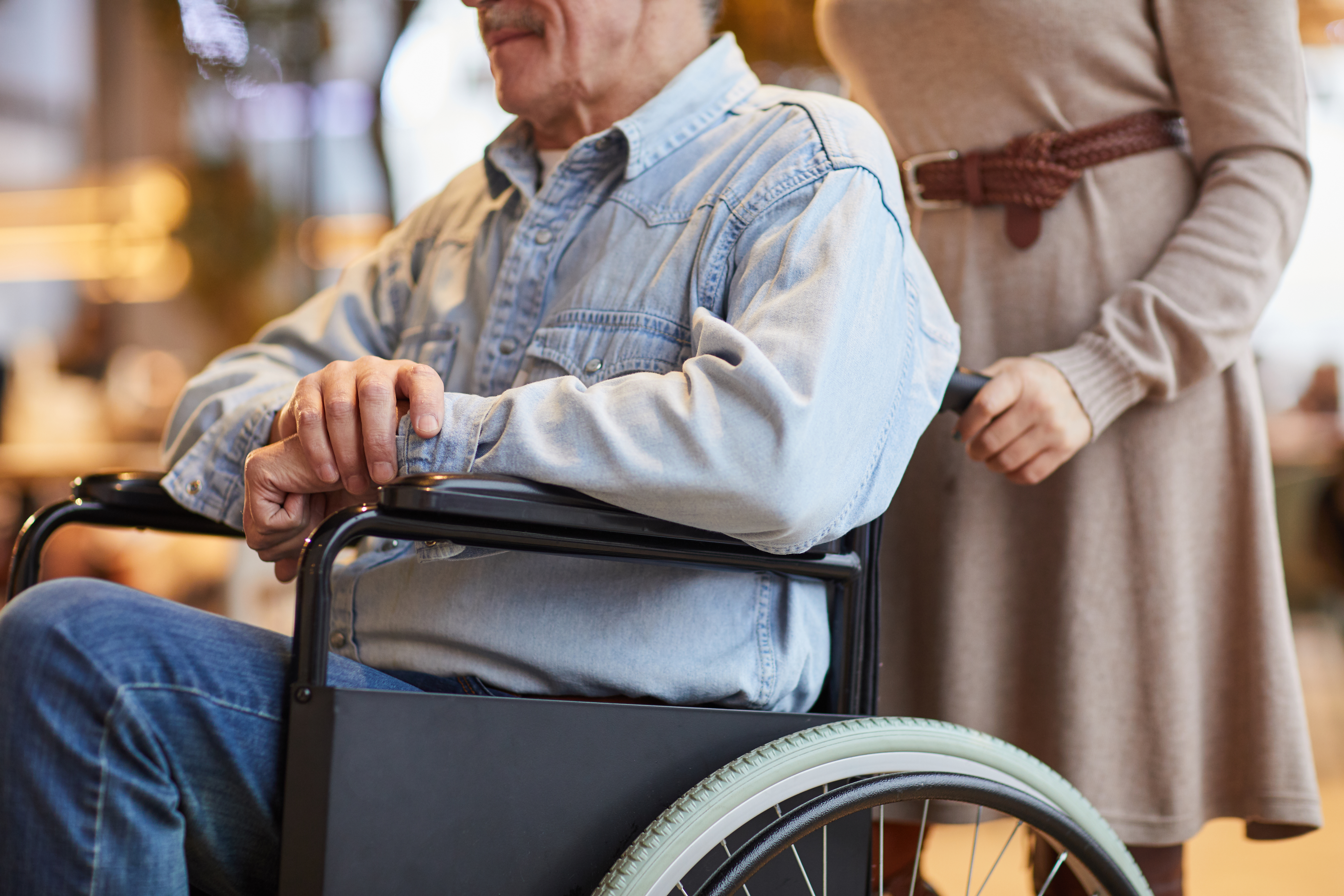 man being pushed in wheelchair