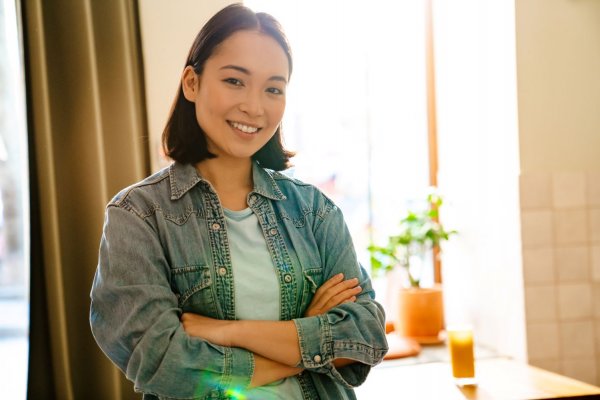 woman smiling with her arms crossed